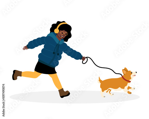 Young girl joyfully walking a corgi on a leash in winter attire during a sunny day