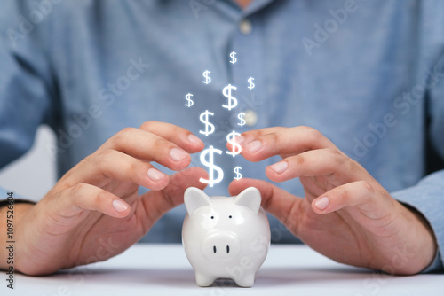 A person protecting a piggy bank with floating dollar signs, symbolizing savings and financial security. photo