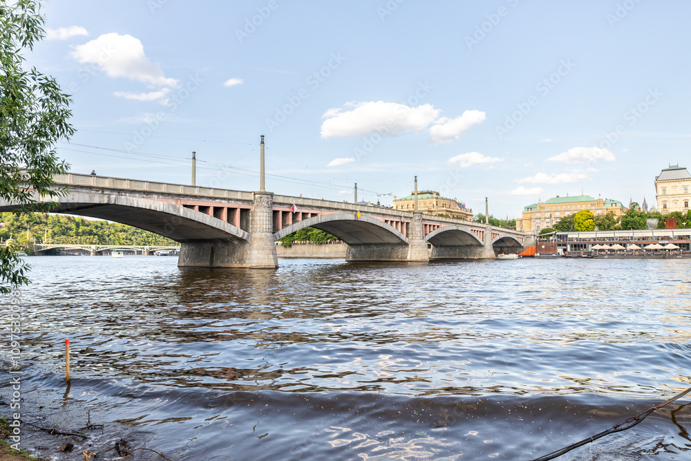View from embankment of the Manes Bridge and opposite embankment on Vltava River in Prague in Czech Republic View from embankment of the Manes Bridge and opposite embankment on Vltava River in Prague in Czech Republic