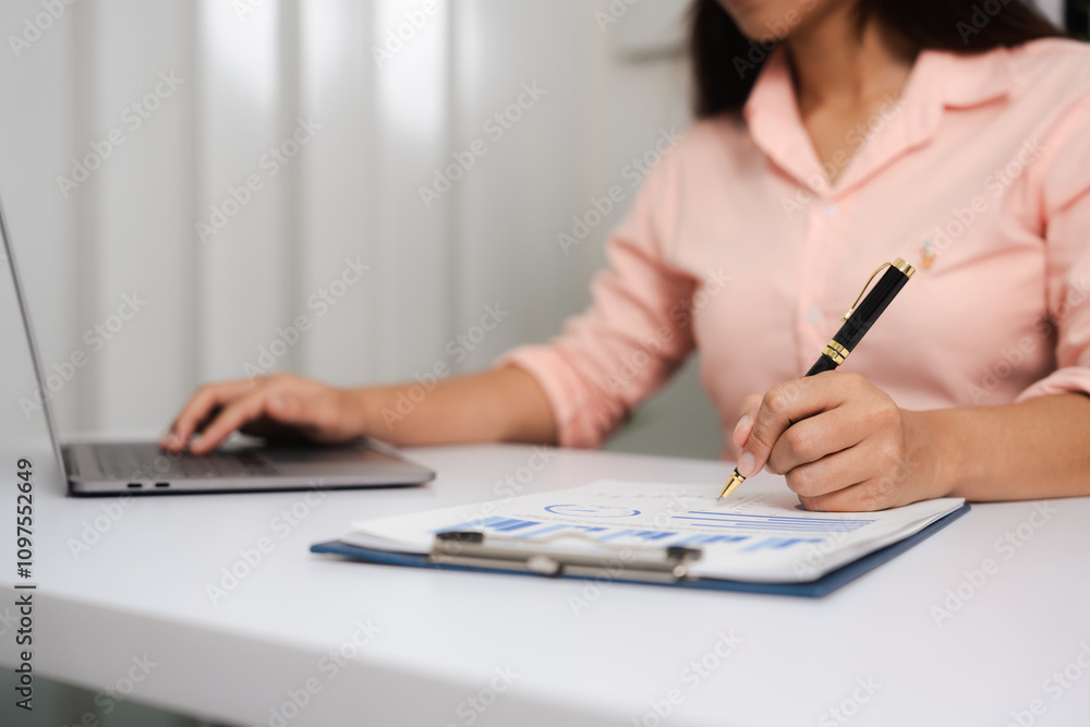 A close-up of a businesswoman working on a laptop in an office. As an accountant, she records financial data, verifies documents, manages income and expenses, ensuring accurate financial reporting A close-up of a businesswoman working on a laptop in an office. As an accountant, she records financial data, verifies documents, manages income and expenses, ensuring accurate financial reporting