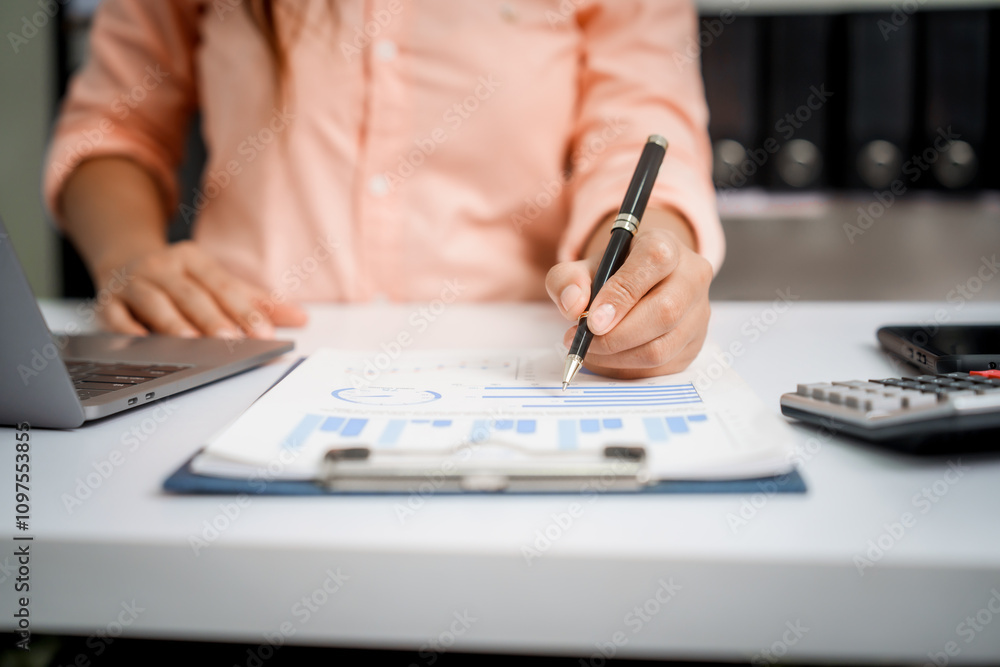 A close-up of a businesswoman working on a laptop in an office. As an accountant, she records financial data, verifies documents, manages income and expenses, ensuring accurate financial reporting A close-up of a businesswoman working on a laptop in an office. As an accountant, she records financial data, verifies documents, manages income and expenses, ensuring accurate financial reporting