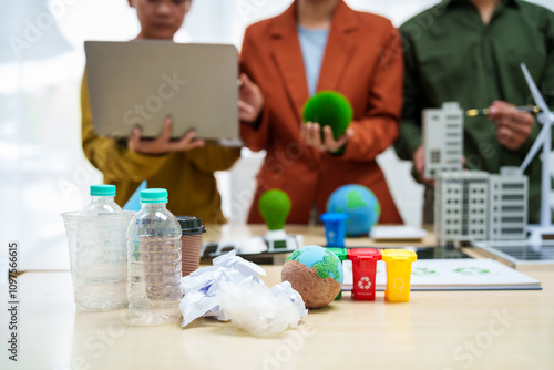 Asian business professionals discuss waste management and recycling strategies at desk, focusing on clean energy initiatives solar panels, electric cars, zero-waste solutions for sustainable future. photo