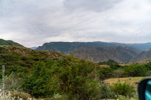 A mountain range with a cloudy sky in the background