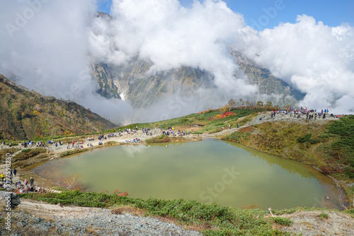 Happo pond, Happo Alpen Line Nature trail, Hakuba, Nagano, Japan, Mountain lake surrounded by clouds and greenery photo