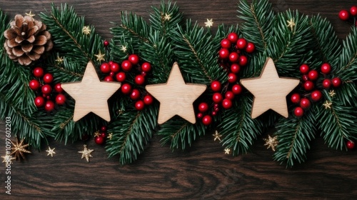 Festive arrangement of wooden stars and red berries on a dark wooden surface, perfect for holiday decor. photo