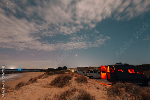 Camper vans parked up under starry night sky at Iluka New South Wales photo