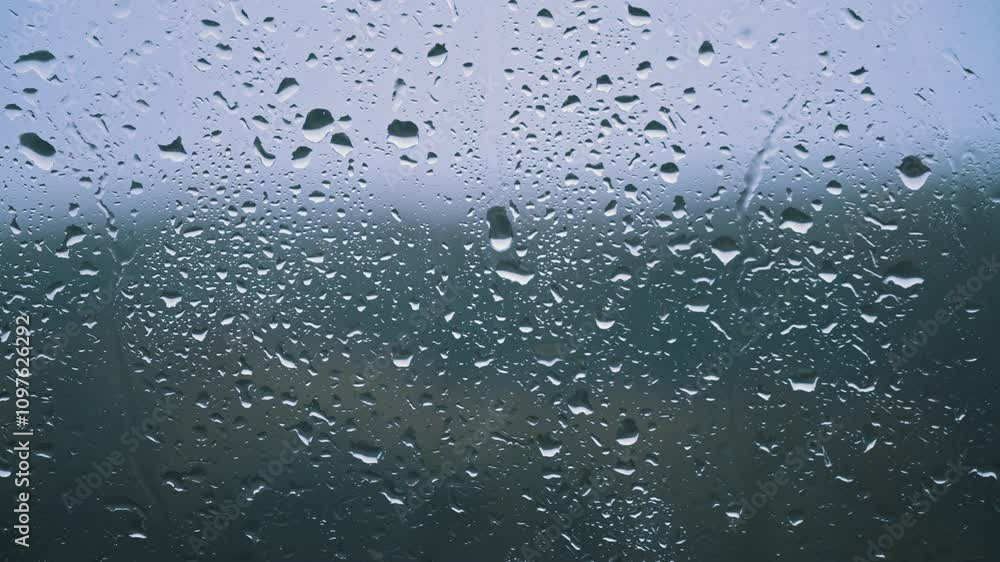 Abstract close-up of numerous rain droplets on a window, creating a textured and atmospheric visual. Ideal for film, video, and design projects needing a moody or reflective feel. Abstract close-up of numerous rain droplets on a window, creating a textured and atmospheric visual. Ideal for film, video, and design projects needing a moody or reflective feel.