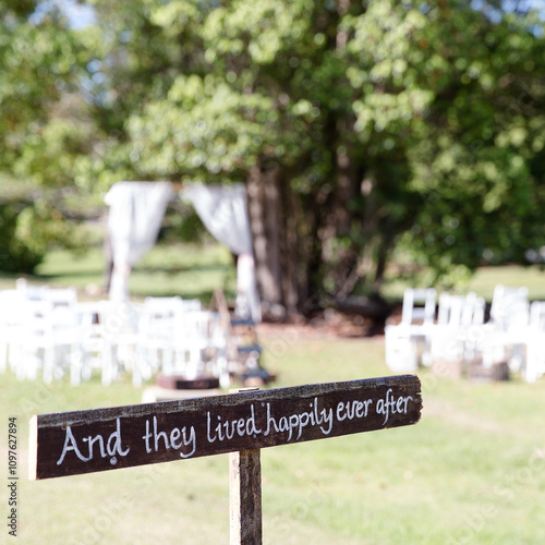 sign saying 'and they lived happily ever after' at an outdoor wedding photo