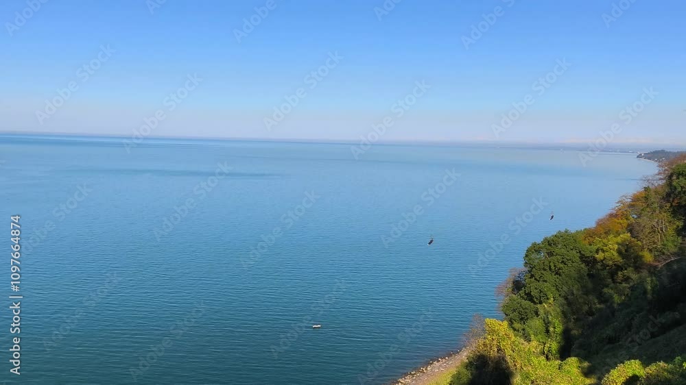 Brave people on a zipline have fun against the backdrop of the sea.
Brave people on a zipline have fun against the backdrop of the sea.