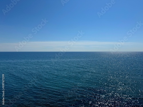 Ocean blue wide waters and blue sky horizon.