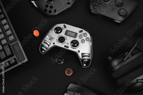 gamer work space concept, top view a gaming gear, mouse, keyboard, joystick on black table background.