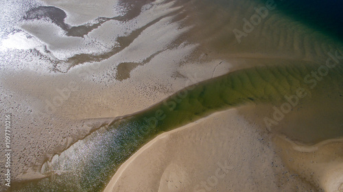 Aerial looking down on sandbars in an estuary. photo