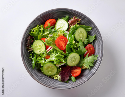 A vibrant bowl of fresh salad showcasing tomatoes, cucumbers, and lettuce, perfect for a healthy meal.