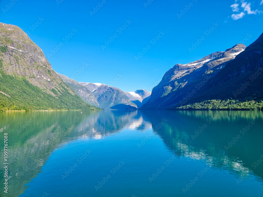 Serene mountain lake reflecting clear blue skies in a tranquil Norwegian landscape Serene mountain lake reflecting clear blue skies in a tranquil Norwegian landscape