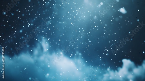 Snowflakes gently falling against a dreamy blue night sky with stars. The foreground has space on the bottom for showcasing a product.