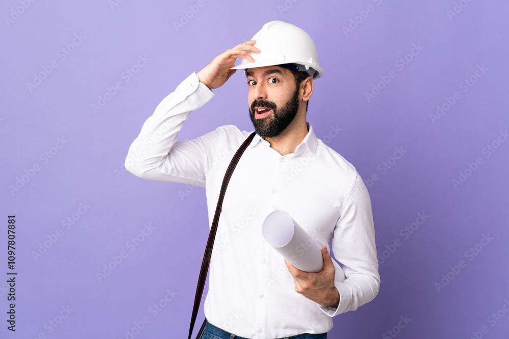 Young architect man with helmet and holding blueprints over isolated purple background doing surprise gesture while looking to the side Young architect man with helmet and holding blueprints over isolated purple background doing surprise gesture while looking to the side