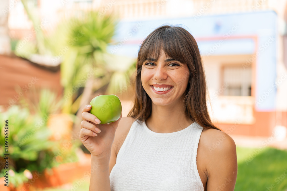 Young woman at outdoors with an apple Young woman at outdoors with an apple