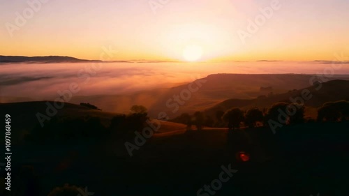 Wallpaper Mural Sunrise Over Misty Valley: A breathtaking panorama of a valley blanketed in mist, illuminated by the golden glow of a rising sun. Torontodigital.ca