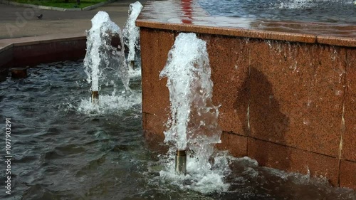 Wallpaper Mural Water splashes from fountain in public square during sunny afternoon
 Torontodigital.ca