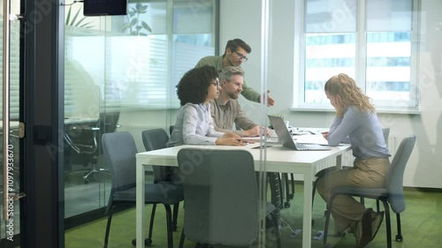 Business office with people casual wear, with blurred bokeh background, view from glass wall