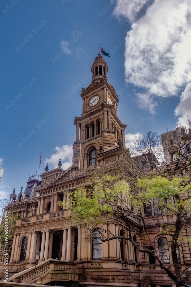 Fototapeta premium Historic clock tower building under a clear blue sky