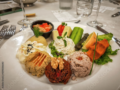 Obraz na płótnie Hors d'oeuvre plate, Antep paste, Hummus, Haydari, Eggplant burial, Lemon, Cucumber, Tomato, Ezine cheese, Izmir tulum cheese. w salonie