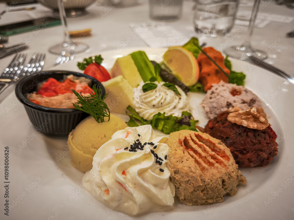 Hors d'oeuvre plate, Antep paste, Hummus, Haydari, Eggplant burial, Lemon, Cucumber, Tomato, Ezine cheese, Izmir tulum cheese.