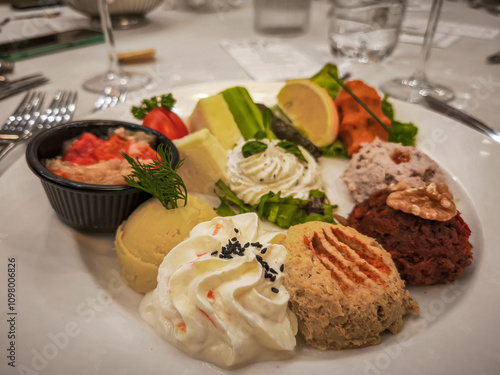 Obraz na płótnie Hors d'oeuvre plate, Antep paste, Hummus, Haydari, Eggplant burial, Lemon, Cucumber, Tomato, Ezine cheese, Izmir tulum cheese. w salonie