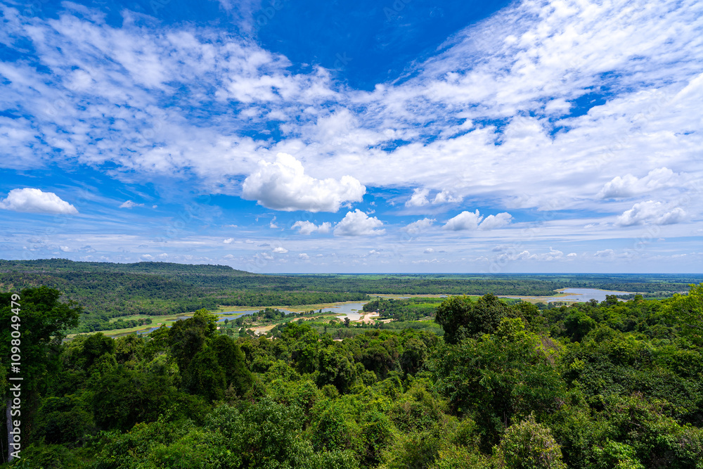 Obraz premium Overhead view. Lake in vast forest with a large area.There is decrease in amount of water. It appeared that a mound of land had turned into grass field. Which is both livestock area and agricultural.