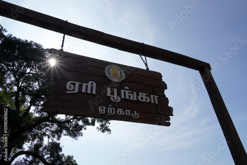 Yercaud, Tamilnadu, India - November 10 2024: Signboard of Yercaud lake park with sun flare effect. Low angle view of Government signboard with blue sky background. photo