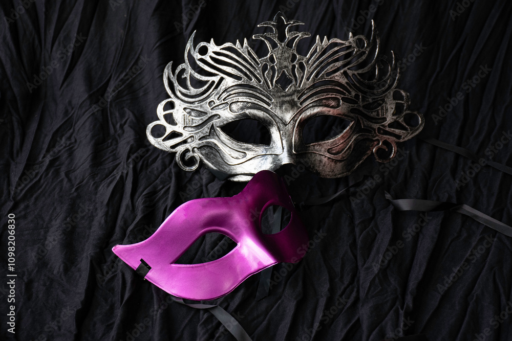 carnival vintage silver mask put on black cloth background.