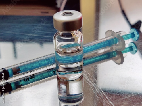 Vaccine in a bottle with a syringe on a medical background.The concept of medicine, healthcare and science.Coronavirus vaccine. Copy space for text photo