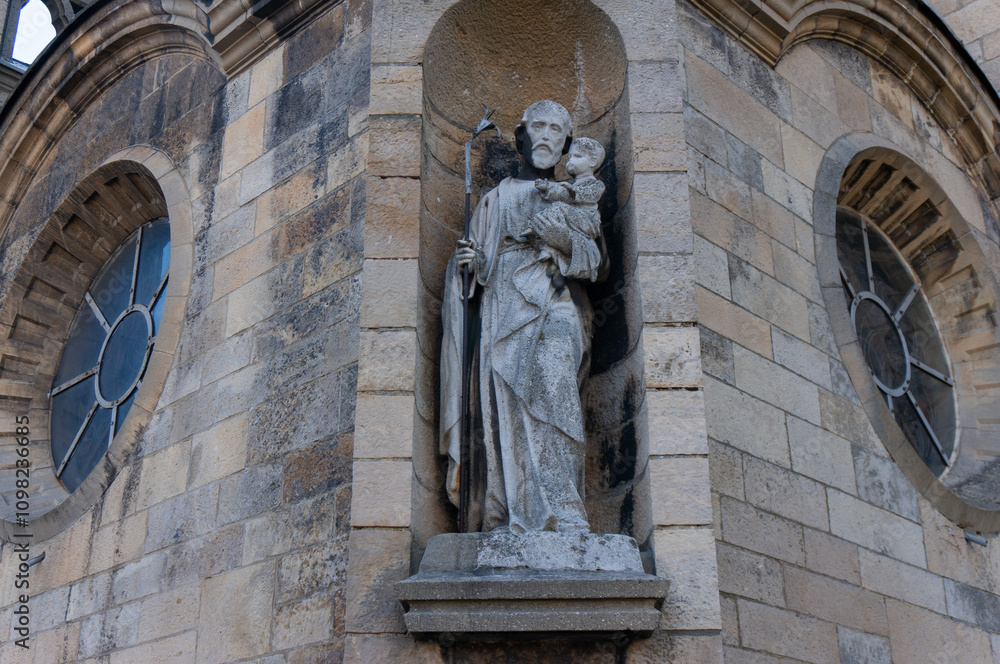 Obraz premium Statue of Saint with Child in niche of Church of Our Lady of the Scapular (kościół Matki Boskiej Szkaplerznej). Imielin, Poland.