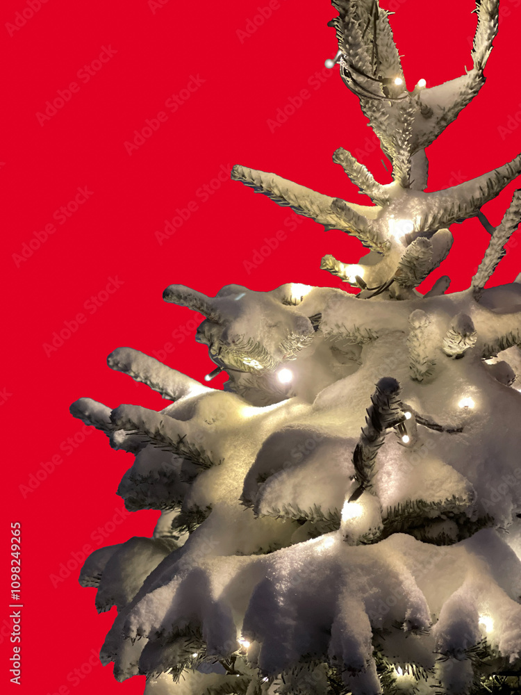 Fototapeta premium Christmas pine tree in snow with lights on red background, copy space, vertical shot