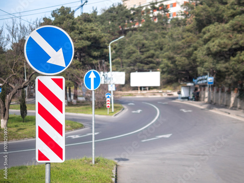 Traffic signs indicating road direction at a junction