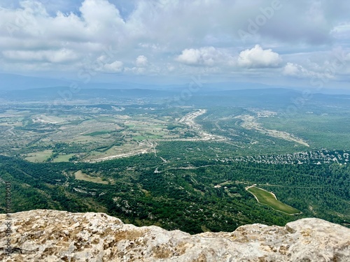 Aerial View from Pic Saint-Loup Overlooking The Giants Marches of Rouet, Surrounding Plains, and Col de Fambetou in Valflaunès, Near Montpellier, Under Partly Cloudy Skies photo