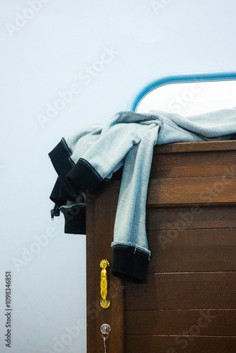 Canvas Print jacket casually draped over a wooden chest, adding a touch of casualness to the space