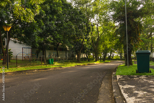 Complex Villa roads line trees with Pedestrian Activity leading to The Taman Dayu luxury housing complex in Pandaan village, Pasuruan, East Java, Indonesia.
 photo