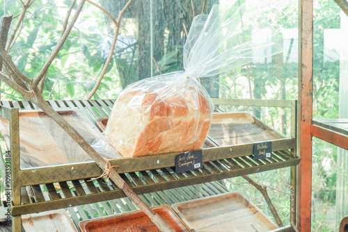 Sliced bread in plastic bag,Close up of a cut slice of bread in bakery shop,Traditional French sweet dessert in forest,Delicious Homemade pastries,selective focus. photo