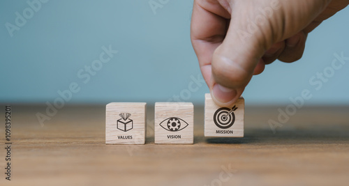 The company's mission, vision, values. purposeful business idea. A hand holds a wooden cube with symbols for purpose, vision, values. contemporary vertical layout. presentation for business. Banner