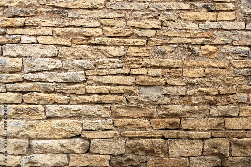 Fototapeta premium yellow beige sand color stone brick vertical wall
