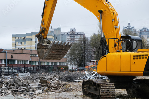 A construction site featuring an excavator set within an urban environment or area