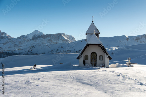 Sunny view of a little chapel near the ski piste in the Alta Badia ski area