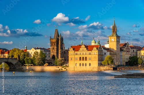 Old Town Bridge Tower (Staroměstská mostecká věž) on the Charles bridge end and XIX century waterworks building  over Vltava River in Prague, Czech Republic