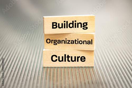 A wooden block with the words Building, Organizational, Culture, Modern approach to working with people in a team, Creative concept, copy space photo