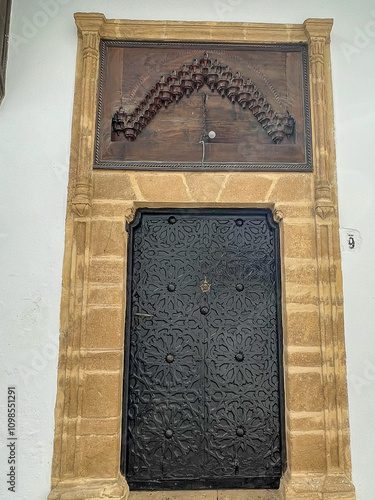 Wooden doors agains white-washed homes in Morocco photo