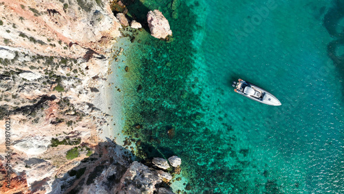 Aerial drone photo of secluded volcanic beach of Kastanas with colourful rock formations and crystal clear emerald sea, island of Milos, Cyclades, Greece photo