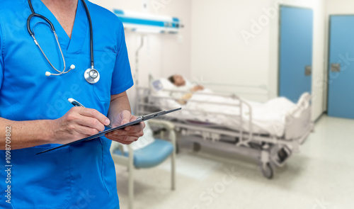 Tableau sur toile Nurse in blue scrubs writing on a clipboard in a hospital room with an ill patient in bed