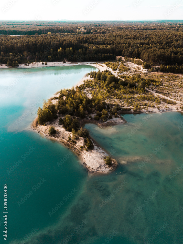 Fototapeta premium Landzunge im blauen See, Kiesgrube von Oben, Luftaufnahme