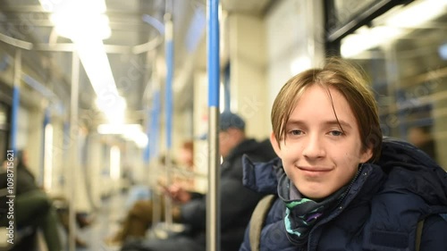 Wallpaper Mural boy in a blue winter jacket sits in a subway train carriage	 Torontodigital.ca